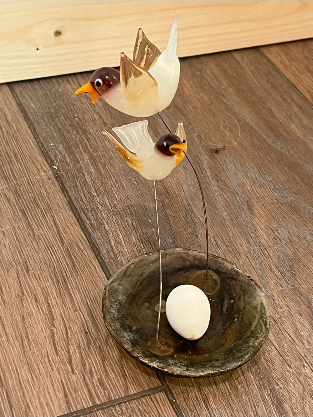 Blown glass bird with nest sculpture